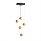 Seven cords cascade travertine and glass spheres at staggered heights from this Clérachic pendant's round canopy.