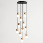 Eleven cords cascade travertine and glass spheres at staggered heights from this Clérachic pendant's round canopy.