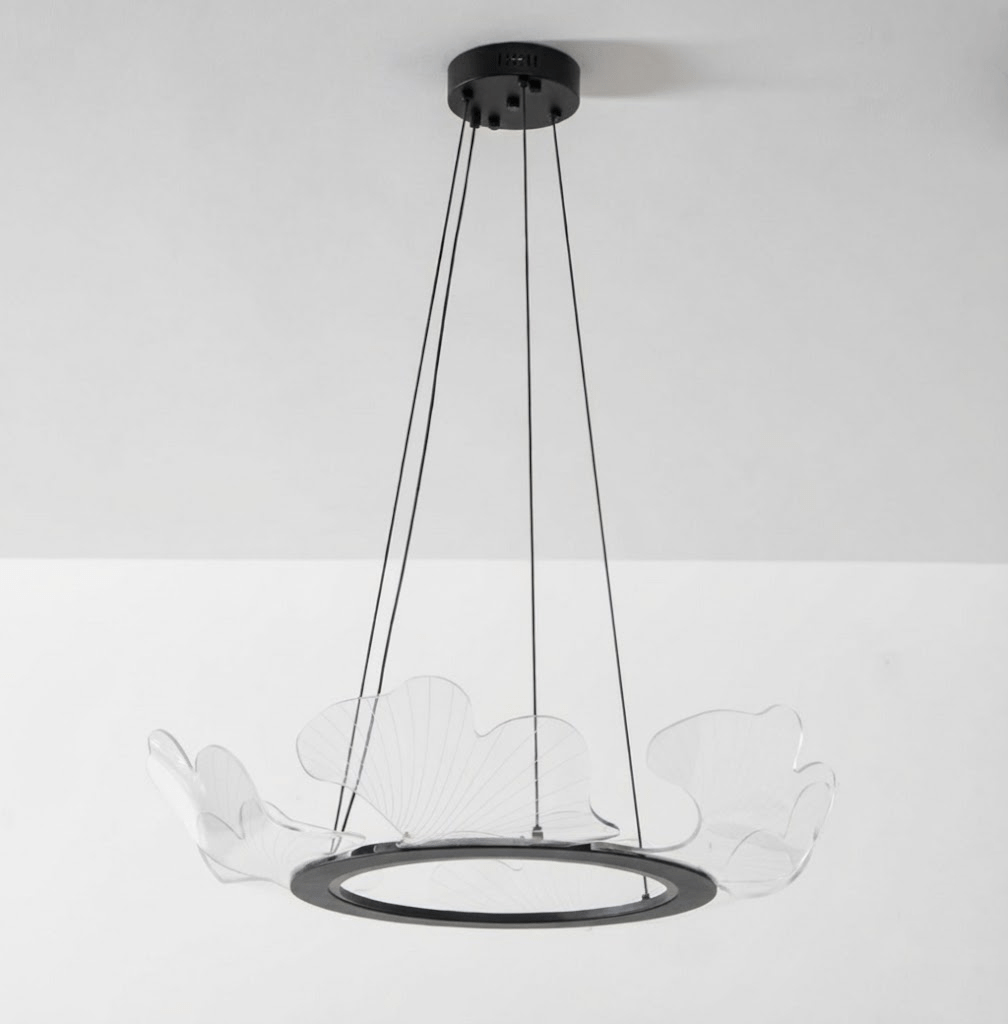 Clear acrylic gold leaf chandelier with a warm glow