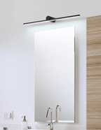 This Clérachic wall light glows above a full-length mirror set against wood panelling near a bathroom sink.