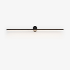 Studio view of a slim black Clérachic wall light, its round pivot mount and bar unlit against white.