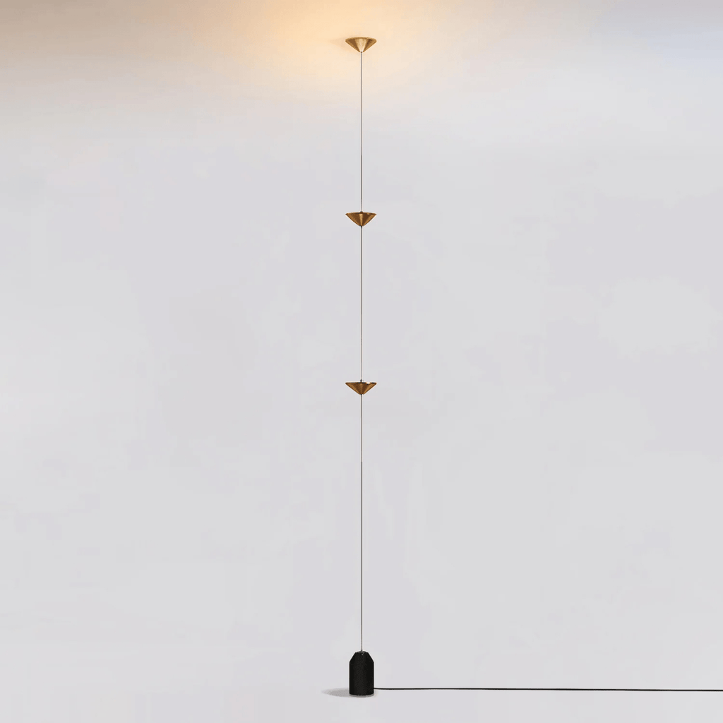 Floor lamp shown beside a sofa in a styled living room