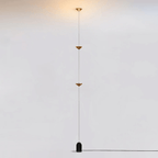 Floor lamp shown beside a sofa in a styled living room