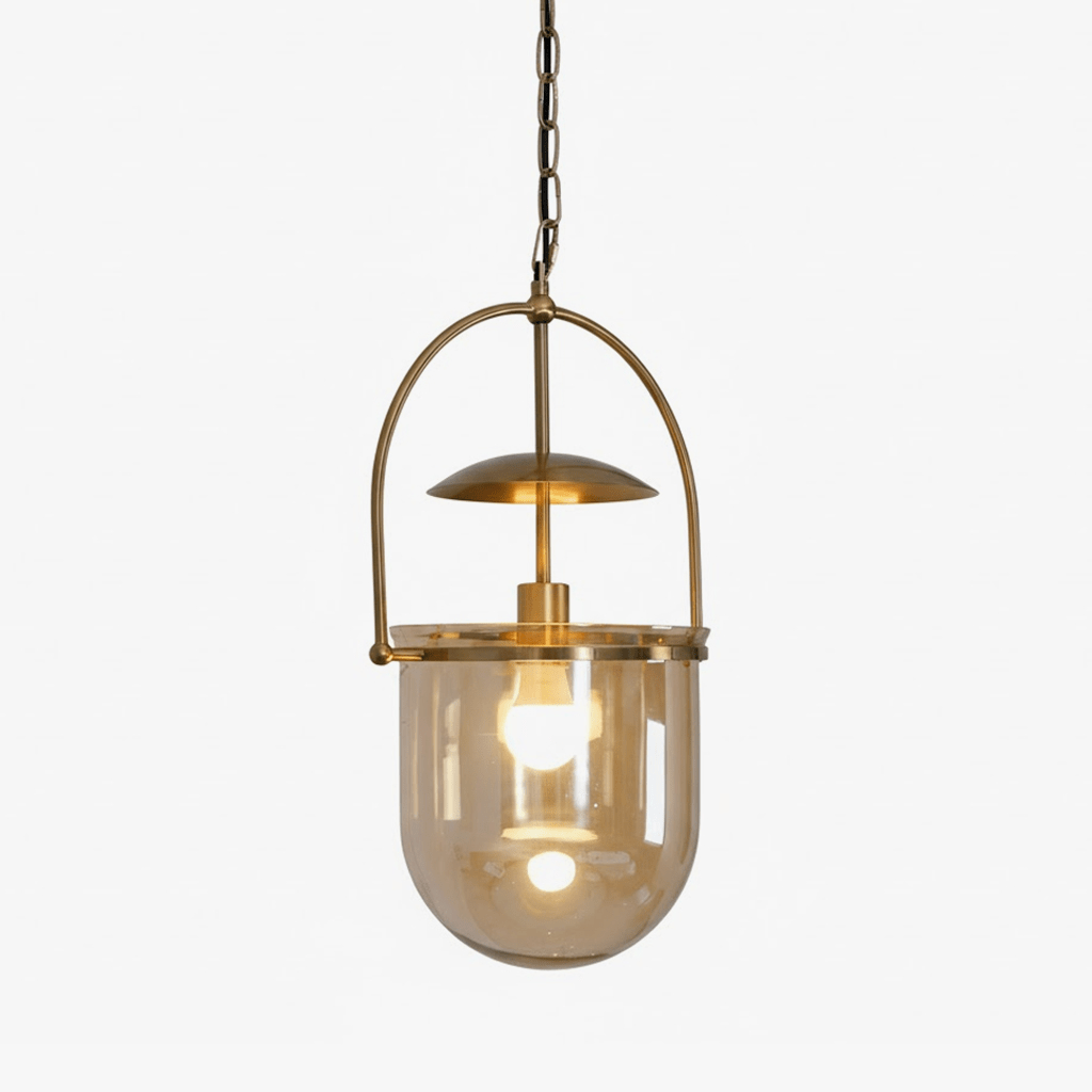 Gold frame pendant light with amber glass shade lit at night