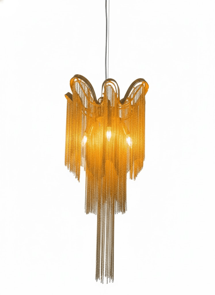 A smaller gold Clérachic chandelier, lit, is shown against a white backdrop with its chain trailing down.