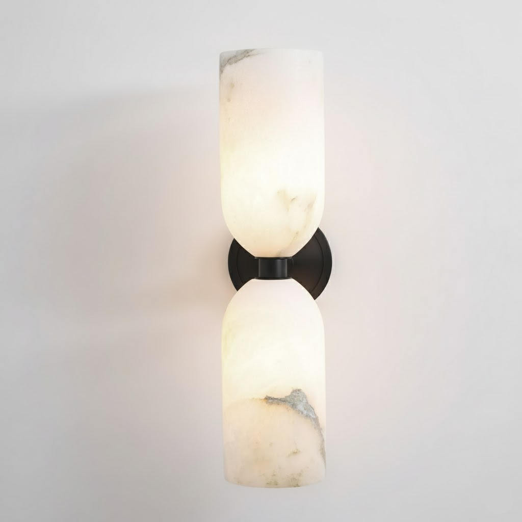 Two natural alabaster columns joined by a metal band on a wall