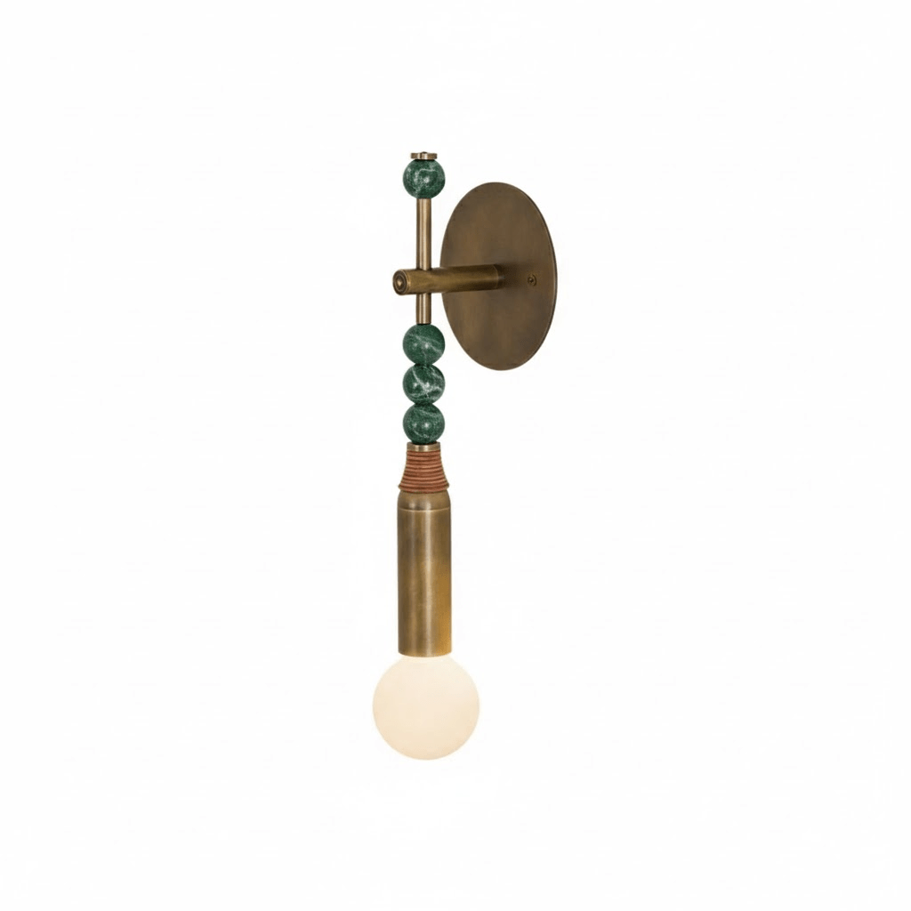 Brass wall lamp with stone accent shown against a plain wall