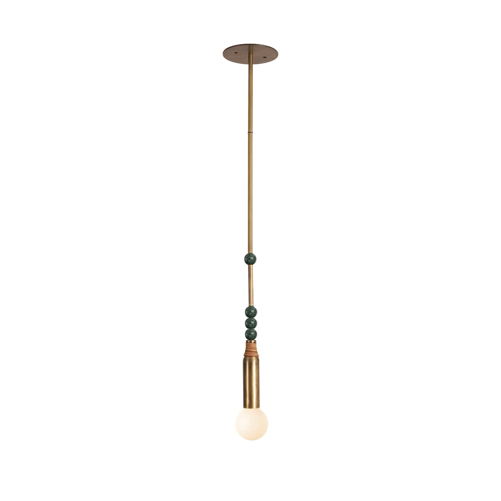 The Clérachic pendant light with green-toned marble beads along its brass drop rod, shown on a plain backdrop.