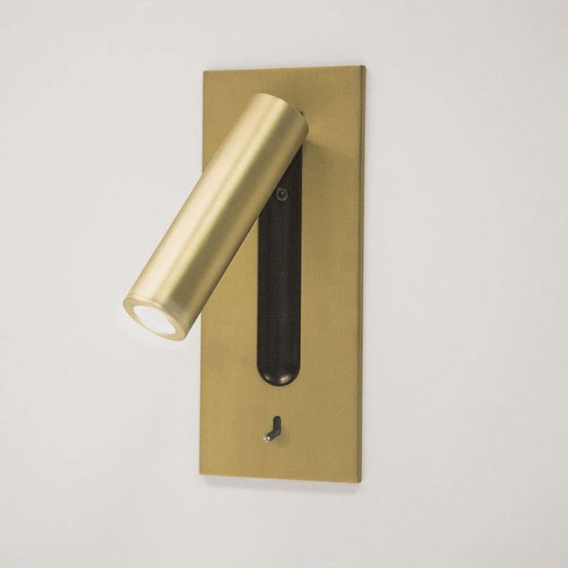 This Clérachic reading light in copper, lit, shown at an angle on a plain off-white background.
