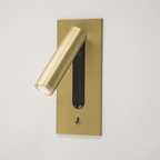 This Clérachic reading light in copper, lit, shown at an angle on a plain off-white background.