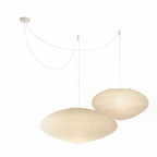 Large washi paper pendant glowing softly over a table
