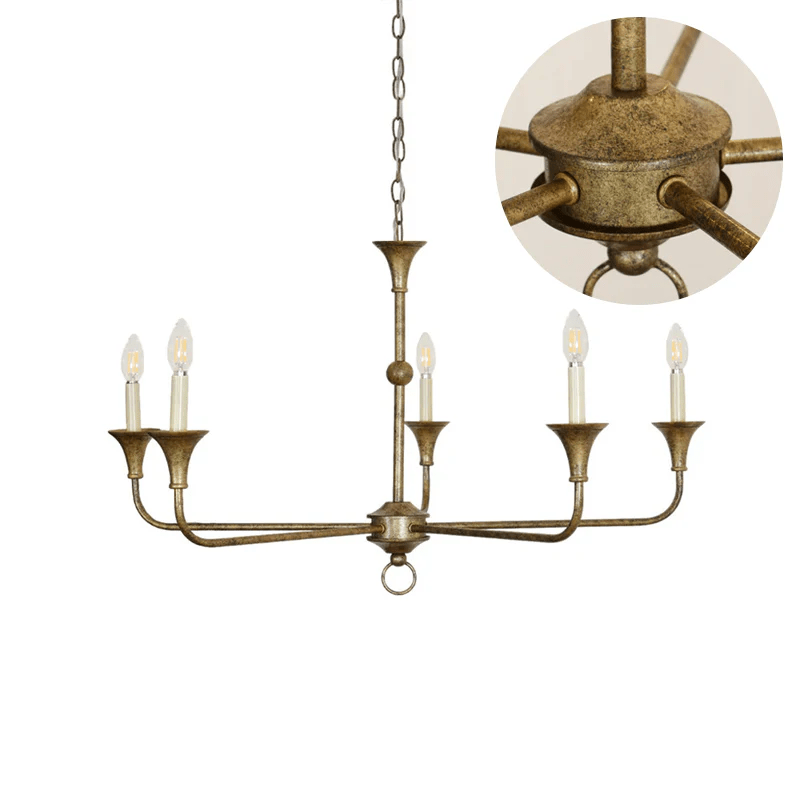 Candle chandelier shown in gold leaf finish against a soft neutral backdrop