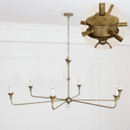 Candle chandelier viewed from below with radiating brass arms
