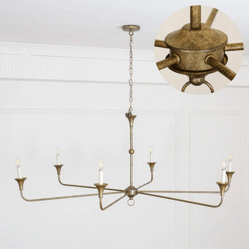 Candle chandelier viewed from below with radiating brass arms