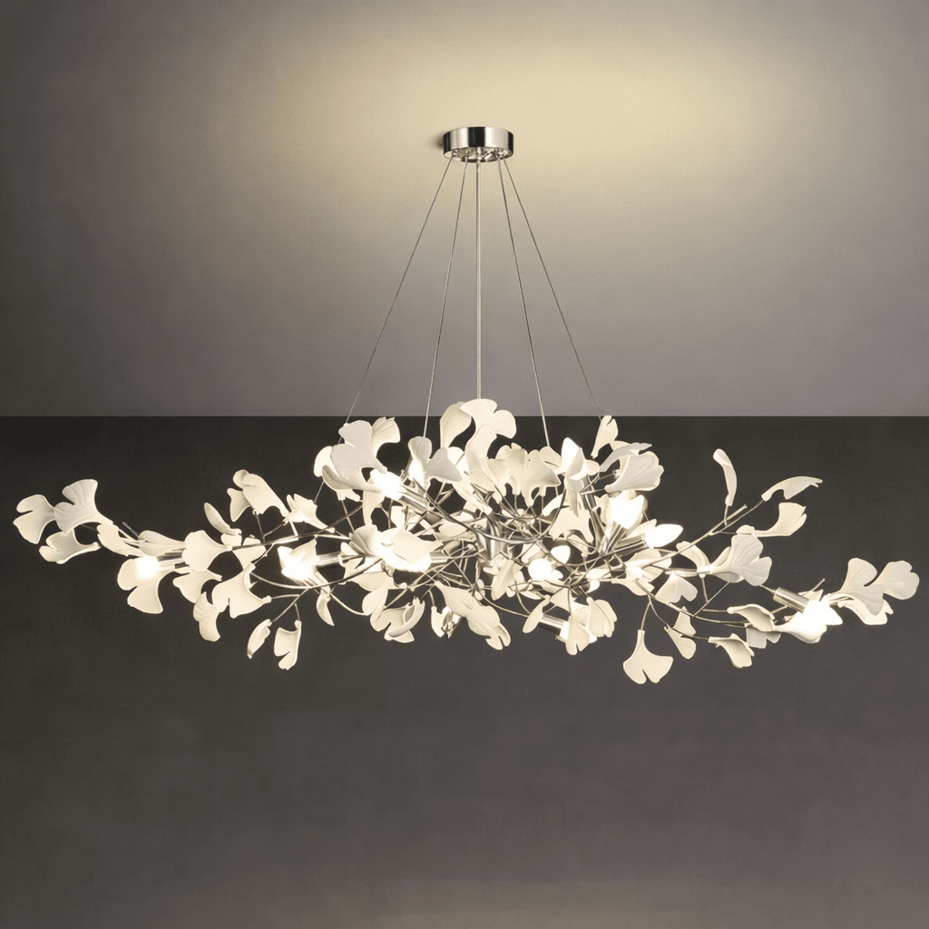Porcelain ginkgo leaves fanned along glowing brass branches