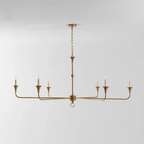 Candle chandelier detail showing slender arms meeting the central column