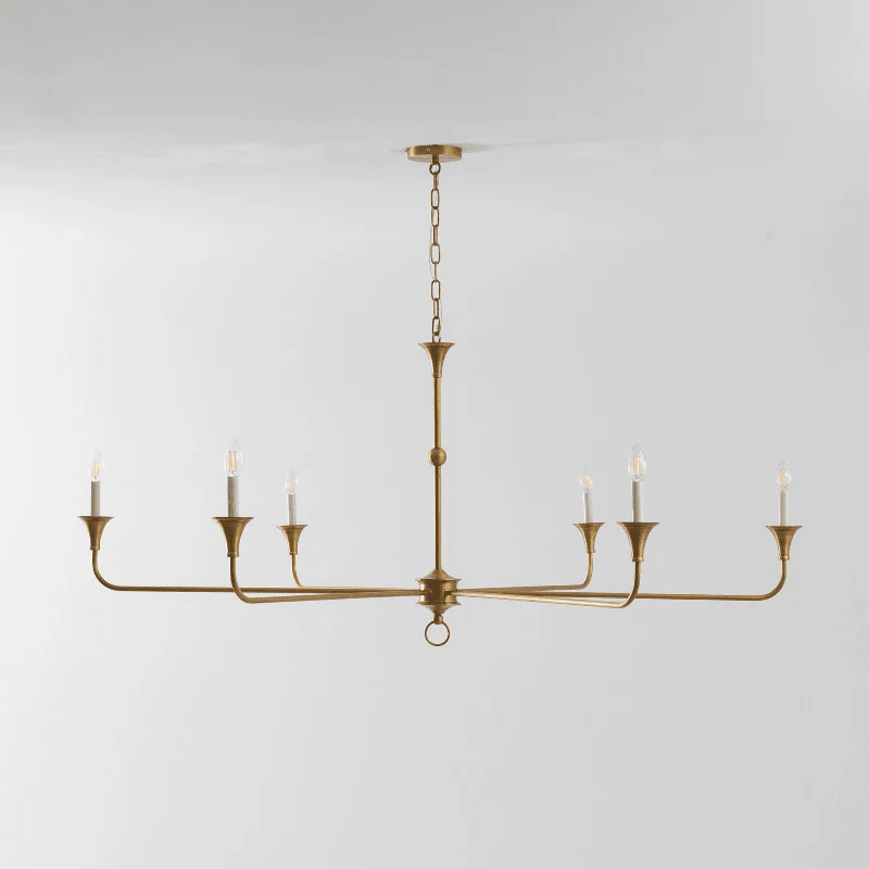 Candle chandelier detail showing slender arms meeting the central column