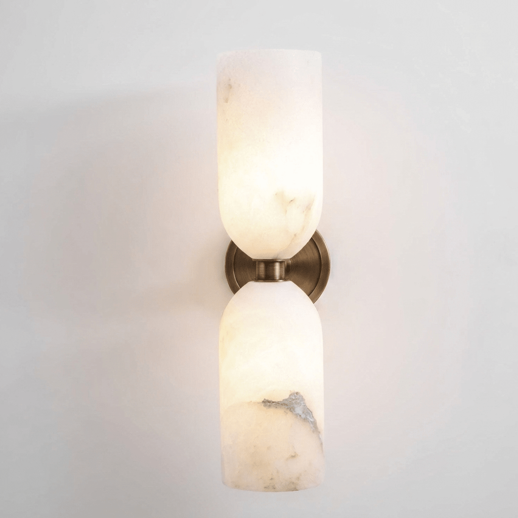 White alabaster wall sconce showing organic stone veining and glow