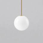 Opal glass globe pendant lights shown in a range of sizes