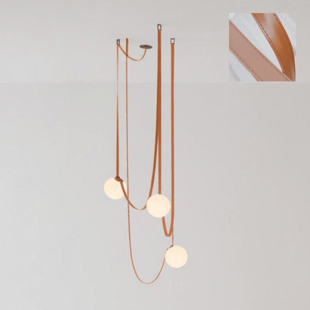 Detail of a belt buckle adjusting the drop height of a glass globe on the pendant light
