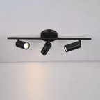 Brass wall spotlight head detail with white acrylic shade