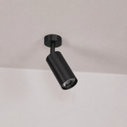 Brass spotlight wall light with rotating heads, lit close-up detail