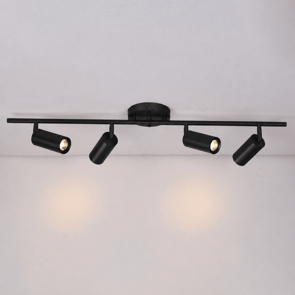 Brass multi-head wall spotlight with GU10 bulbs lit