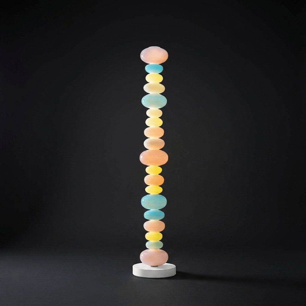 Against a dark studio backdrop, this Clérachic floor lamp's stacked glass globes glow brightly from base to crown.