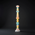 Against a dark studio backdrop, this Clérachic floor lamp's stacked glass globes glow brightly from base to crown.