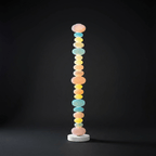 Against a dark studio backdrop, this Clérachic floor lamp's stacked glass globes glow brightly from base to crown.