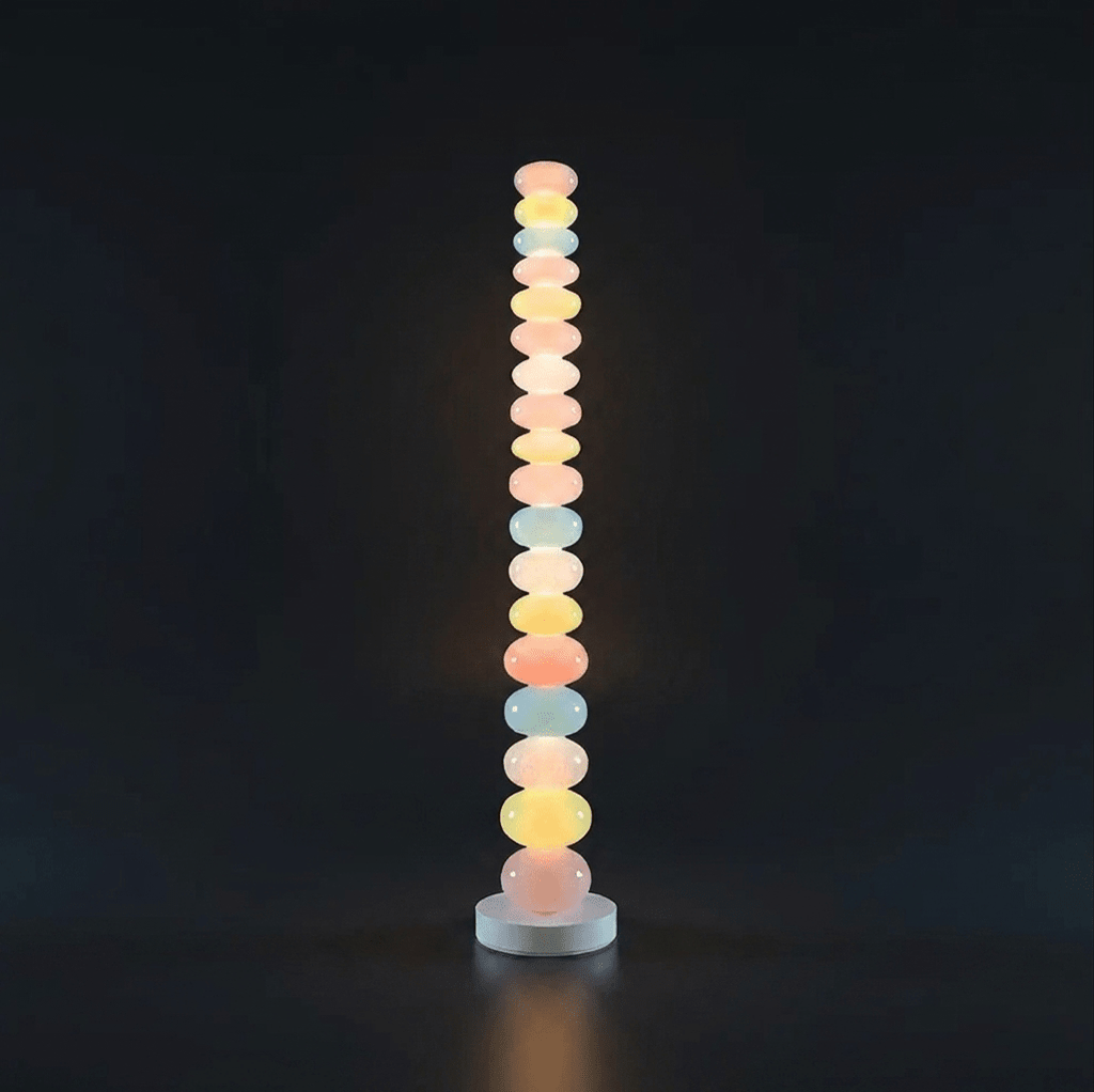 Photographed against a black backdrop, this Clérachic floor lamp's column of glass globes glows softly from top to base.
