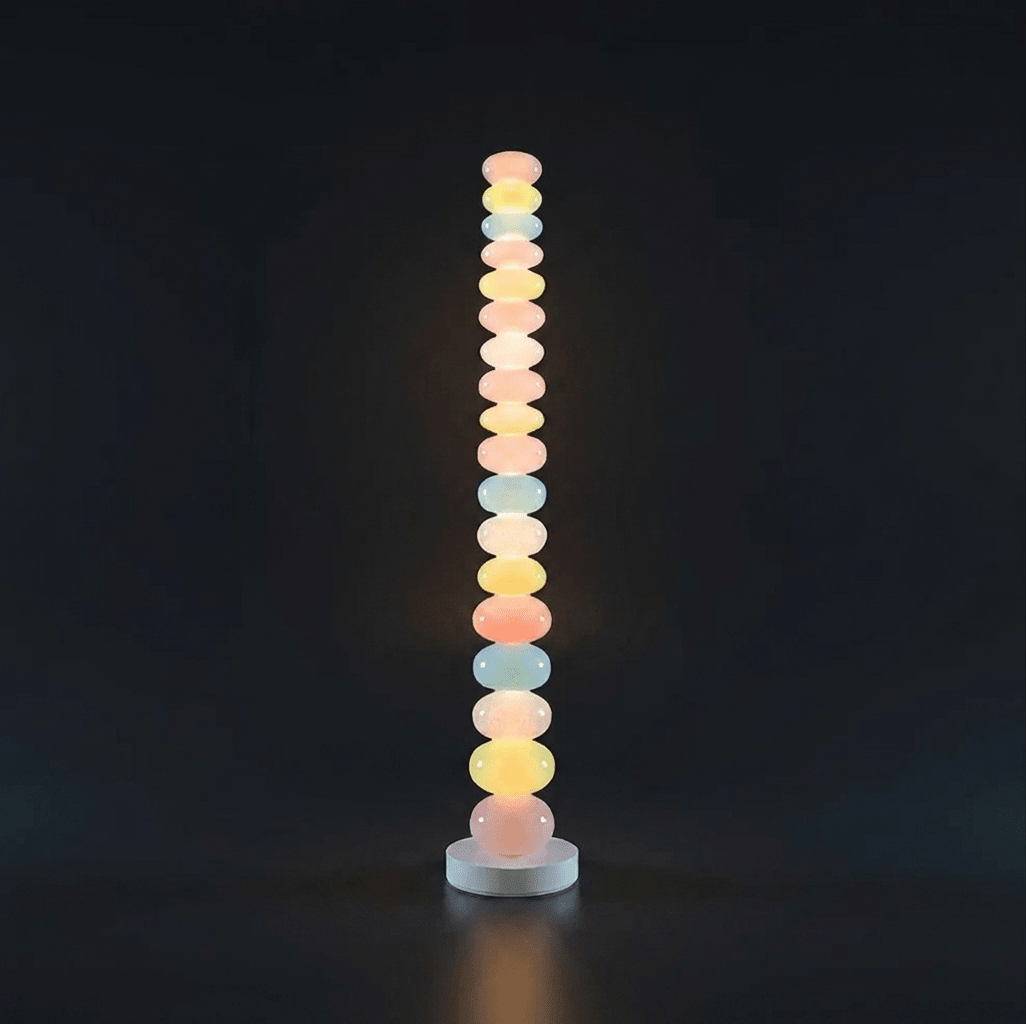 Photographed against a black backdrop, this Clérachic floor lamp's column of glass globes glows softly from top to base.