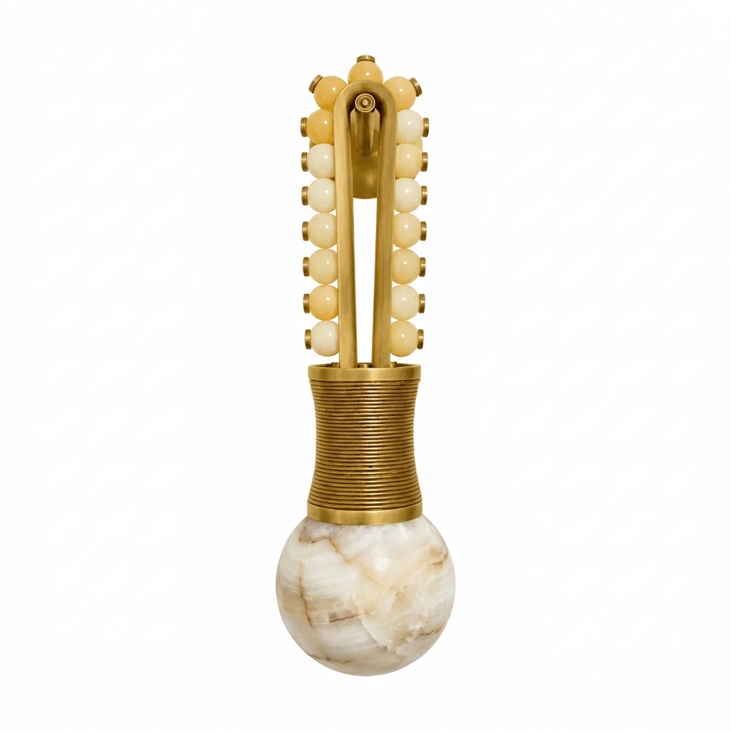 In an isolated view, this Clérachic wall light shows a brass frame with golden-toned beads leading down to the alabaster globe.
