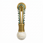 Isolated against white, this Clérachic wall light pairs a brass frame with teal-green beads and a brass-wrapped base.