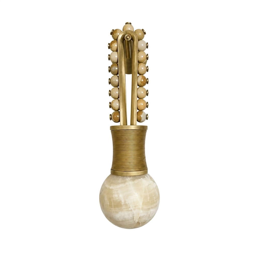 On a plain backdrop, this Clérachic wall light shows warm tan beads set into a brass frame above the globe.