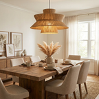 Framed by botanical prints and a vase of pampas grass, this Clérachic pendant lights a table surrounded by linen chairs.