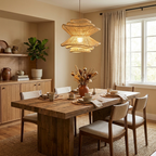 Above a wood dining table with a fiddle-leaf fig nearby, this Clérachic pendant tapers between two wave-edged tiers.