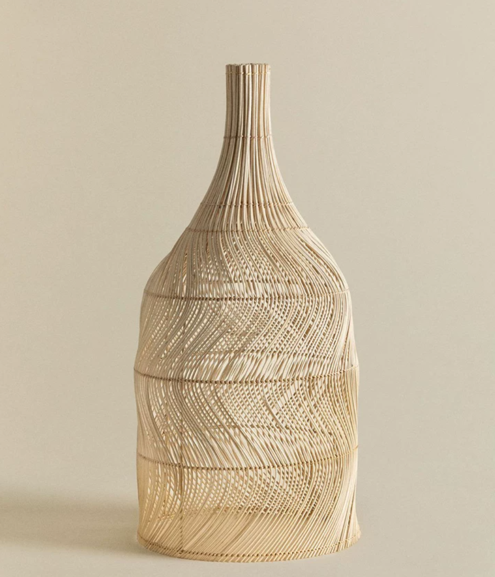 Close view of the woven rattan texture on this Clérachic pendant, its neck tapering to a narrow top.