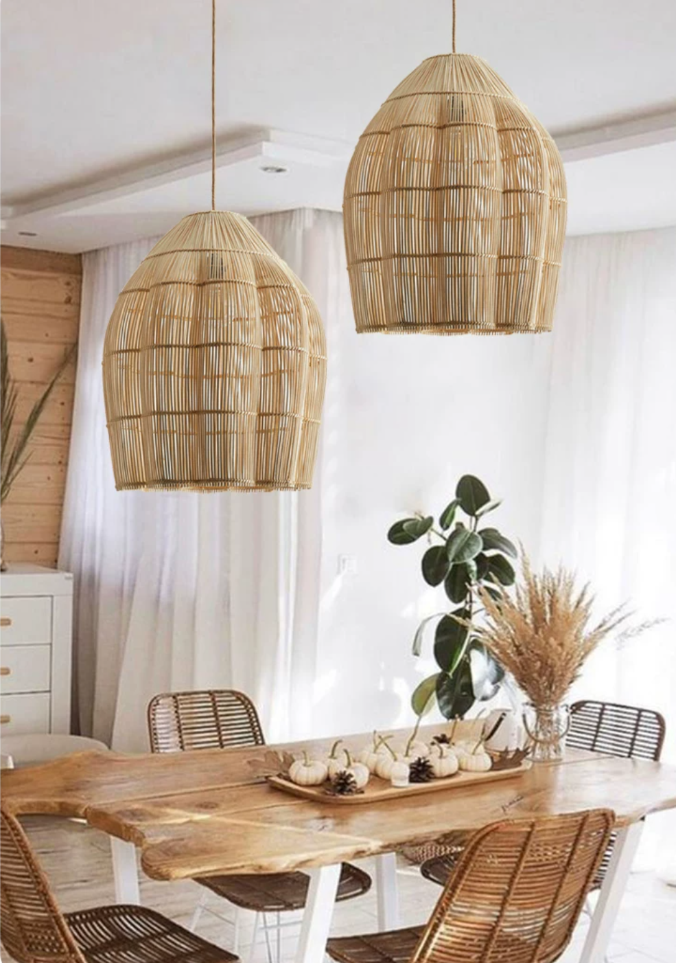 This Clérachic pendant is shown in a pair, hanging above a live-edge dining table with a eucalyptus centrepiece.