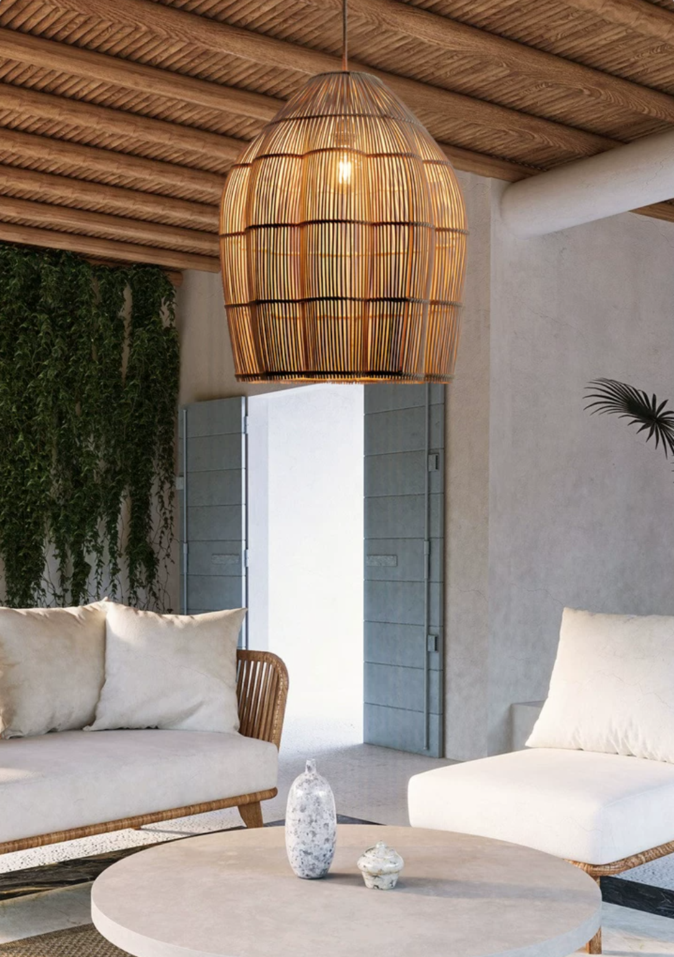 This Clérachic pendant glows beneath a wood-beamed ceiling, with cream outdoor seating and a courtyard view beyond.