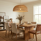 This Clérachic pendant hangs above a wood dining table near a shiplap wall and a tall window.