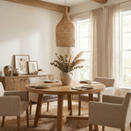 Above a round oak table with beige upholstered chairs, this Clérachic pendant hangs near a eucalyptus centrepiece.
