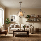 Above a coffee table near open bookshelves, the nickel finish of this Clérachic pendant lights a living room sofa area.