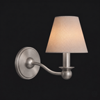 This brushed nickel Clérachic wall sconce, unlit, is shown as a cutout with its single fabric drum shade.