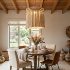 Beside a garden-facing window, this Clérachic pendant lights a round table set with teacups and dried pampas grass.