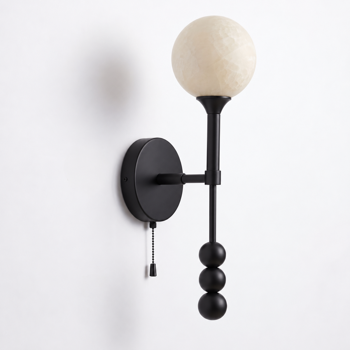 Front-facing studio shot of this Clérachic wall sconce in matte black against a plain white backdrop.