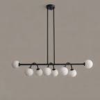 This Clérachic chandelier in matte black is shown from the side, its two rods mounted to a round canopy.