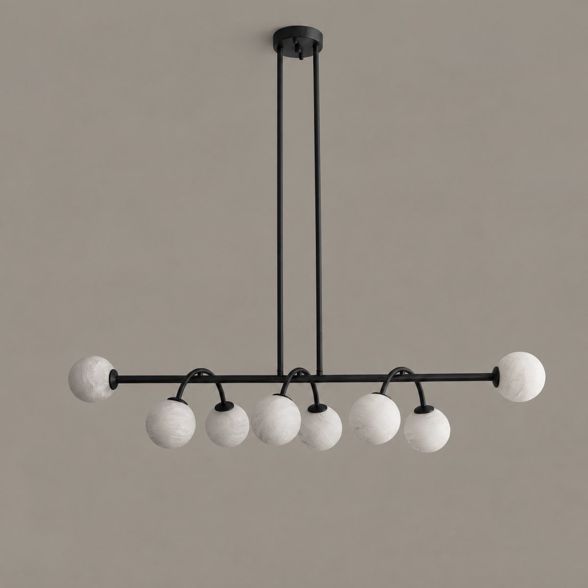 This Clérachic chandelier in matte black is shown from the side, its two rods mounted to a round canopy.