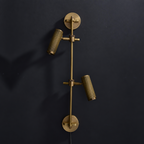Studio shot of this Clérachic plug-in spotlight in bronze finish against black, its cord visible below.