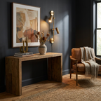 In an entryway with dark walls, this Clérachic plug-in spotlight in bronze finish lights a console table.